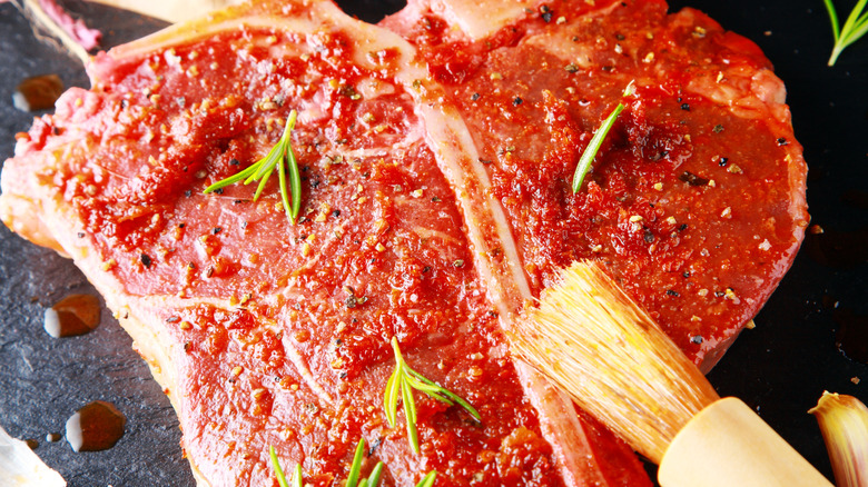 raw porterhouse with seasoning blend