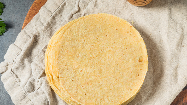 corn tortillas stacked on a towel