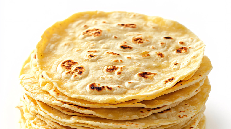 flour tortillas stacked against white background