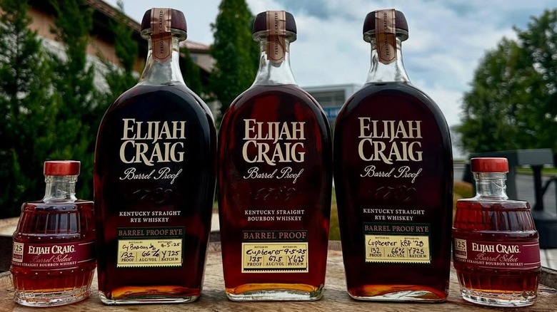 five bottles of Elijah Craigh whiskey on an outdoor table