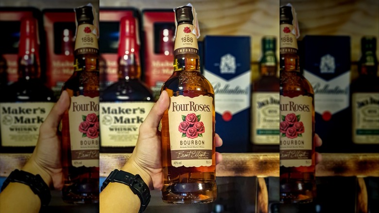Bottle of Four Roses Bourbon in hand