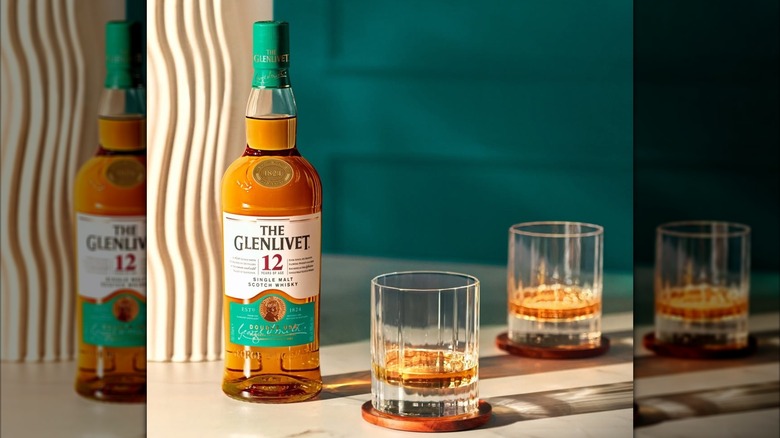 bottle of The Glenlivet 12 Single Malt Scotch with glasses