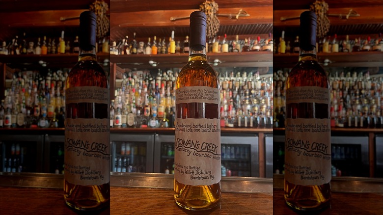 bottle of Rowan's Creek bourbon on a bar