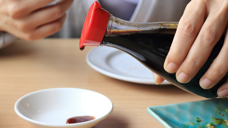 pouring soy sauce into dish