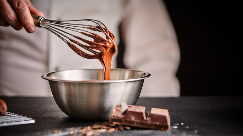 Chocolate dripping off of a whisk