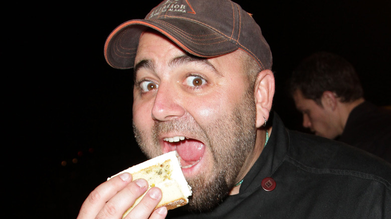 Duff Goldman smiling and eating cake