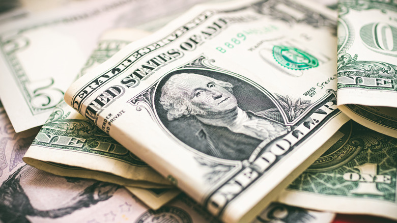 A pile of one and five dollar bills