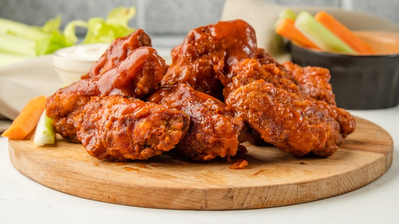 Chicken wings on a wooden serving board