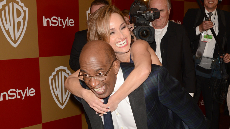 Giada De Laurentiis getting a piggyback ride from Al Roker