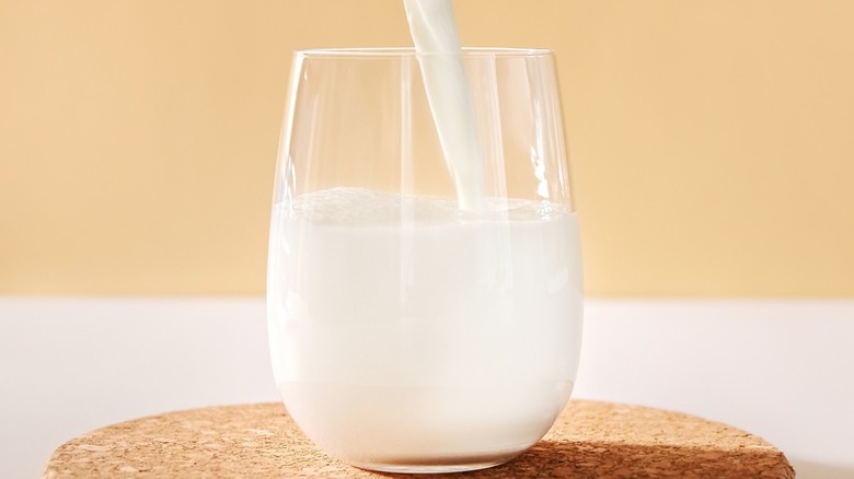 pouring milk in stemless glass 