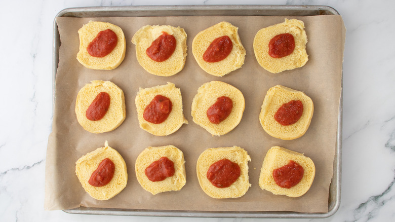 slider buns with tomato sauce in a pan