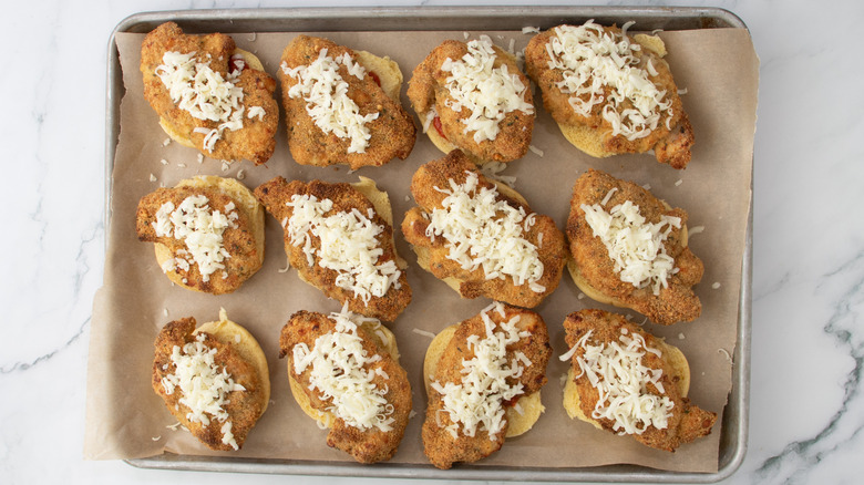 slider buns with chicken and cheese in a pan