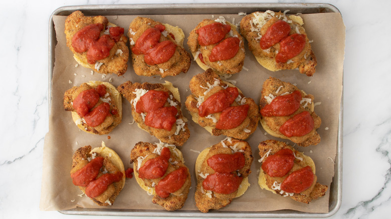 slider buns with chicken and tomato sauce in a pan