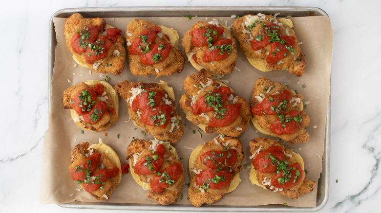 slider buns with chicken and tomato sauce in a pan