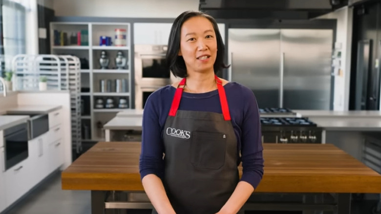 Lan Lam of America's Test Kitchen, blurry kitchen in the background