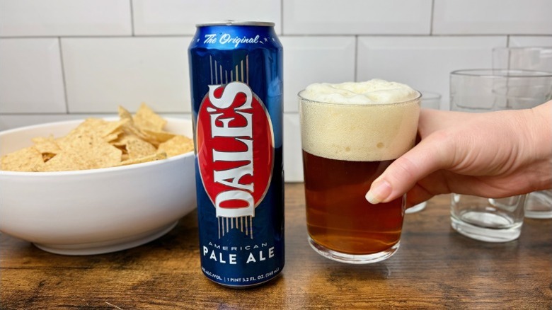 Dale's Pale Ale in a glass next to the can and a bowl of tortilla chips