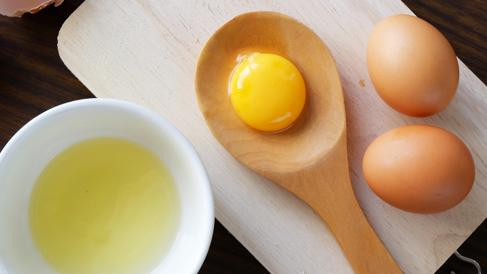 Separated eggs on cutting board