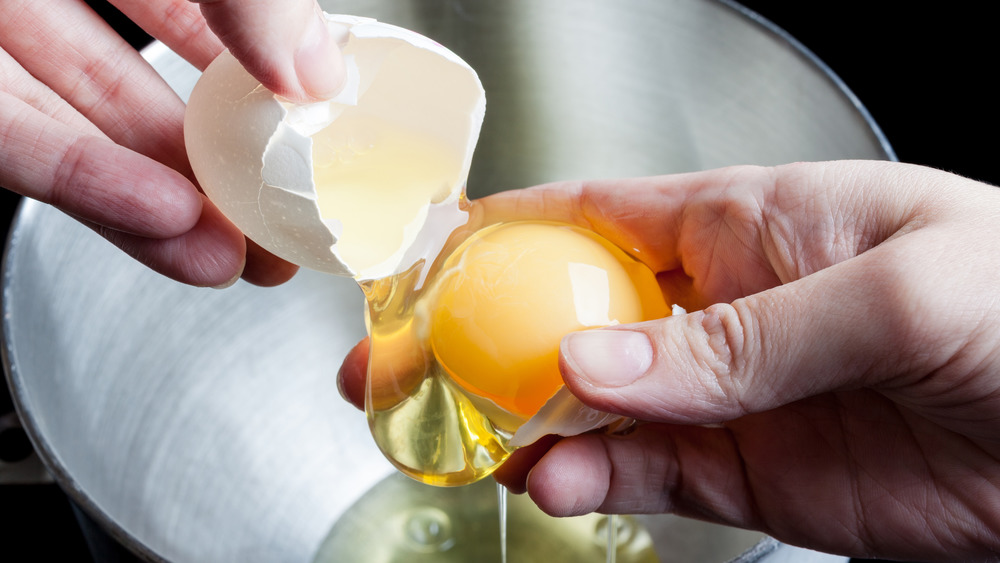 Holding egg yolk and shell