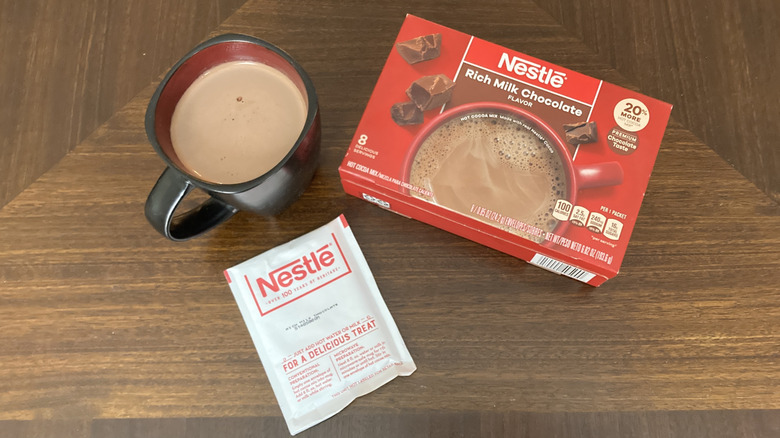 Nestle hot chocolate mix with a mug of hot chocolate