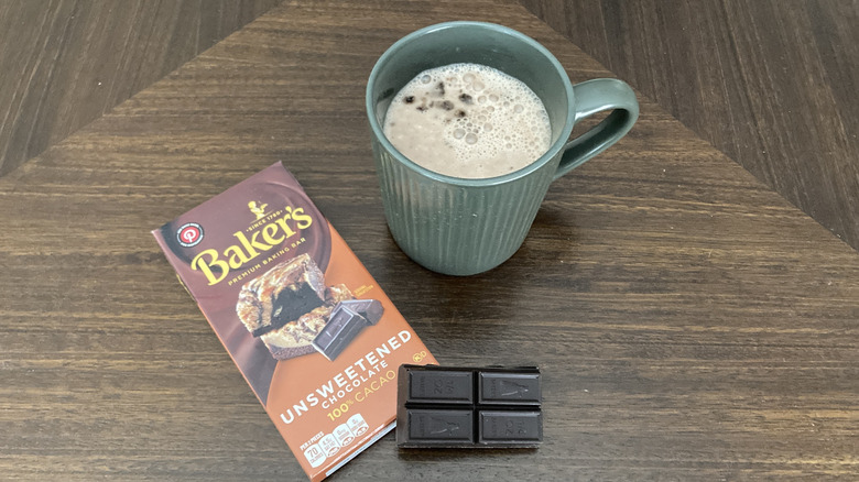 Mug of hot chocolate with a bar of baking chocolate