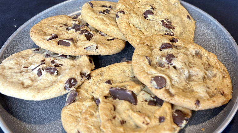 pile of six chocolate chip cookies on gray plate