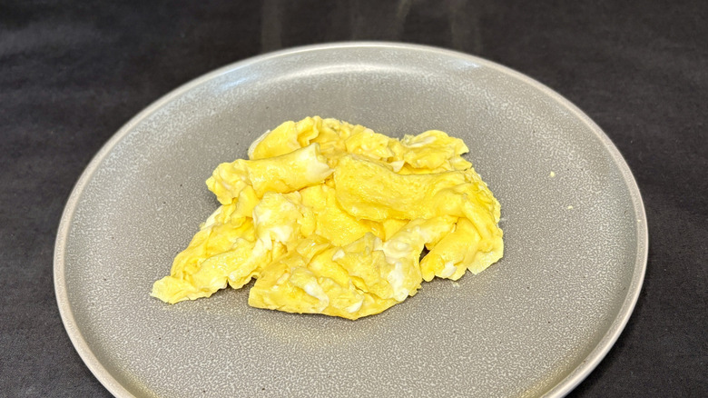 Scrambled eggs on grey plate
