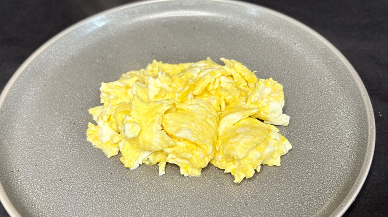 Scrambled eggs on grey plate