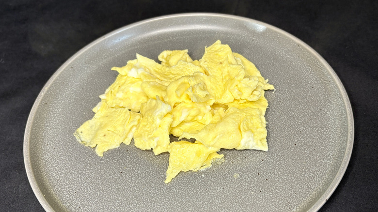 Scrambled eggs on grey plate