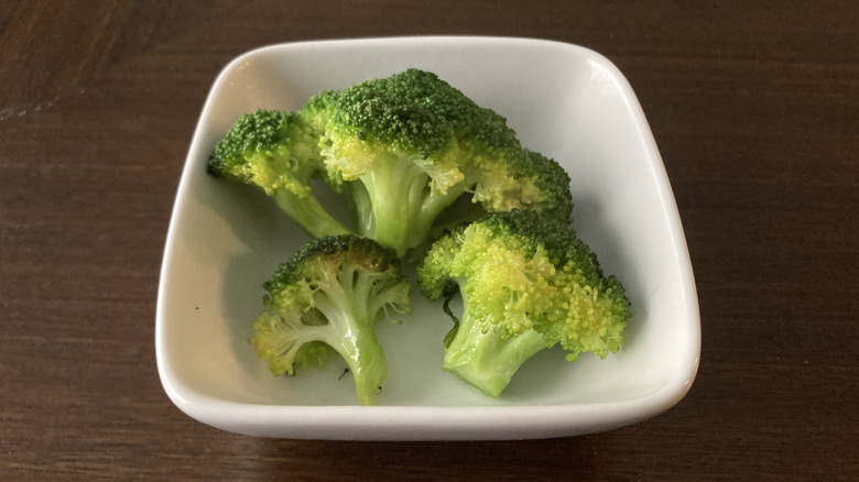 Grilled broccoli stems in white bowl