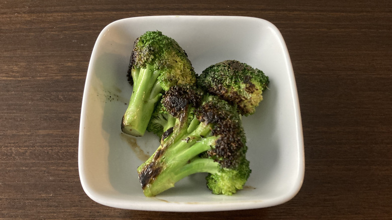 Three broccoli florets sauteed in plant butter