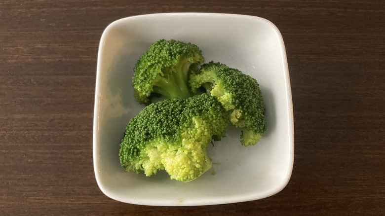 White dish of steamed broccoli stems
