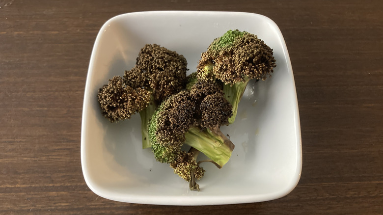White bowl of scorched air fried broccoli