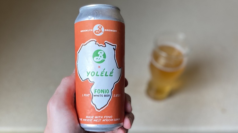 Beer held above glass