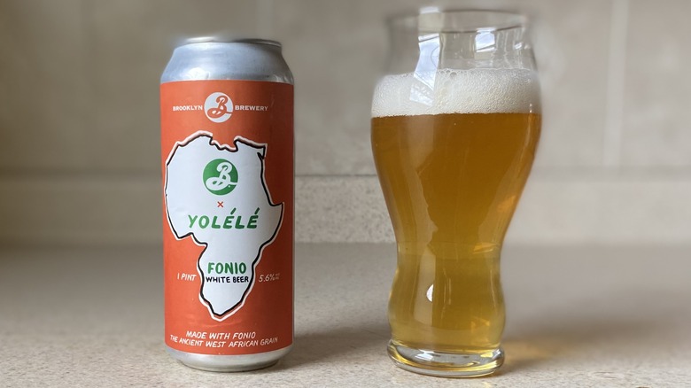 Beer poured in glass by can