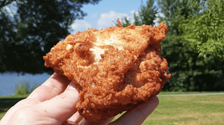 holding KFC chicken breast