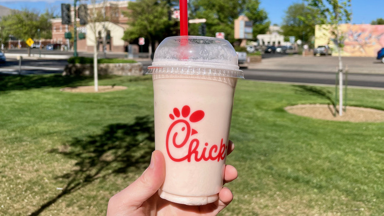 hand holding frosted cloudberry lemonade