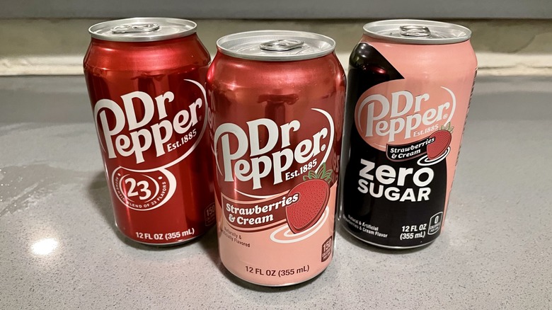 Three cans of Dr Pepper