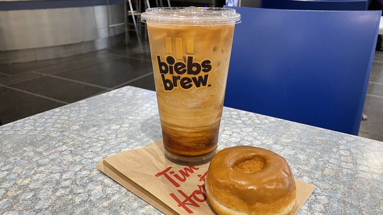 A large iced Biebs Brew and maple doughnut 