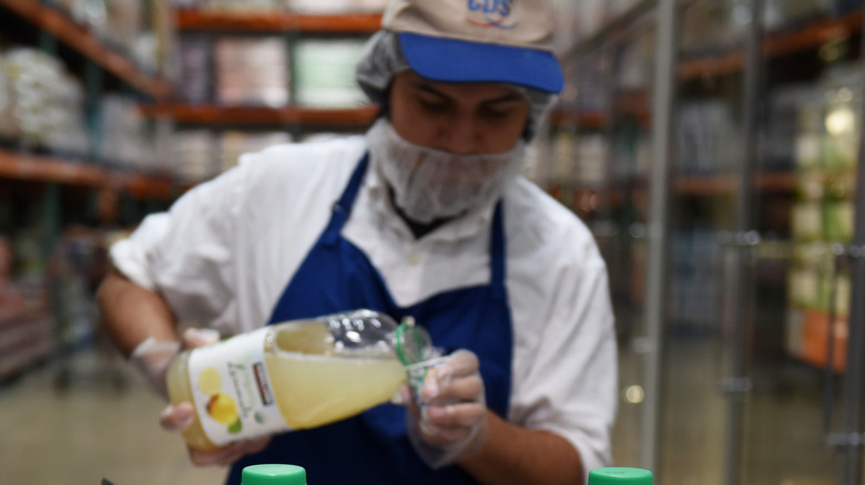 CDS sample pours juice Costco