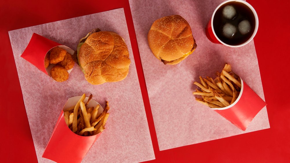 A spread of two Wendy's meals on a red background 