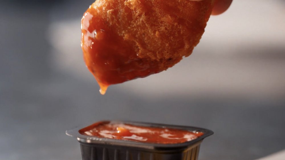 closeup of McDonald's spicy McNugget and Mighty Hot Sauce