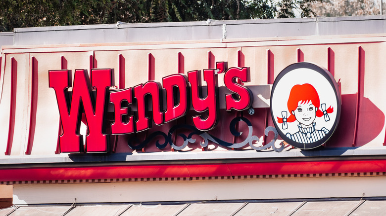 Wendy's sign and logo on the side of a building