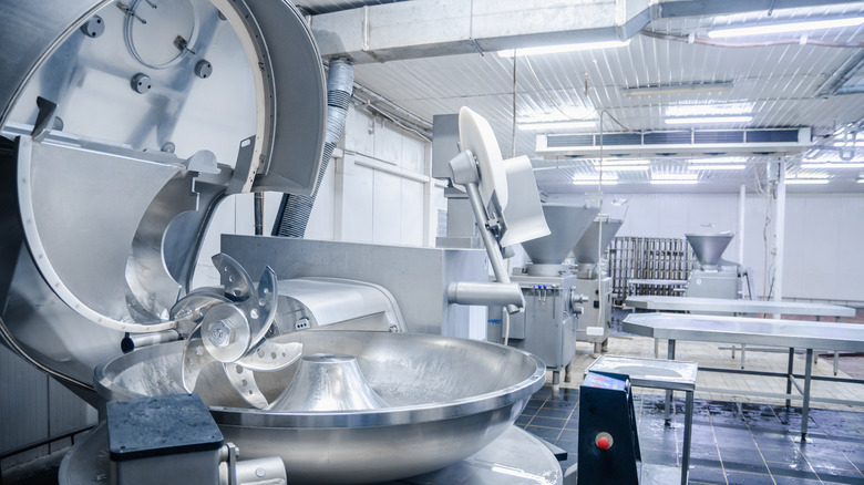 Industrial meat grinder in a factory