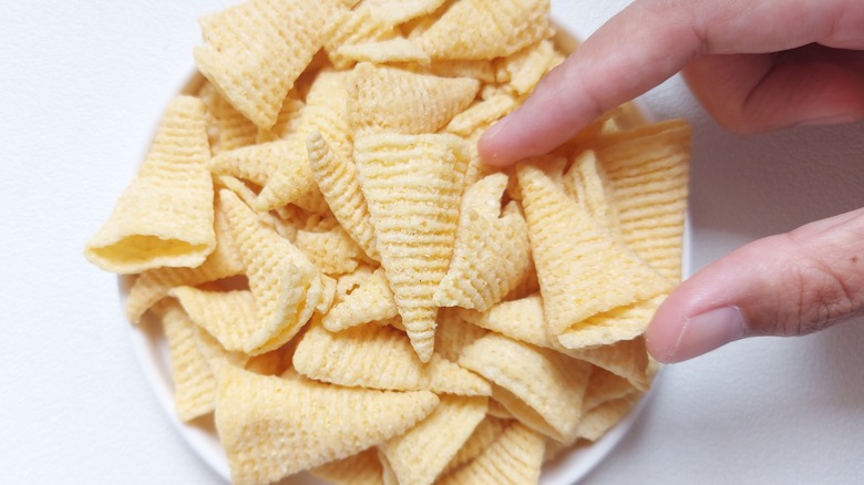 hand taking Bugles from a bowl