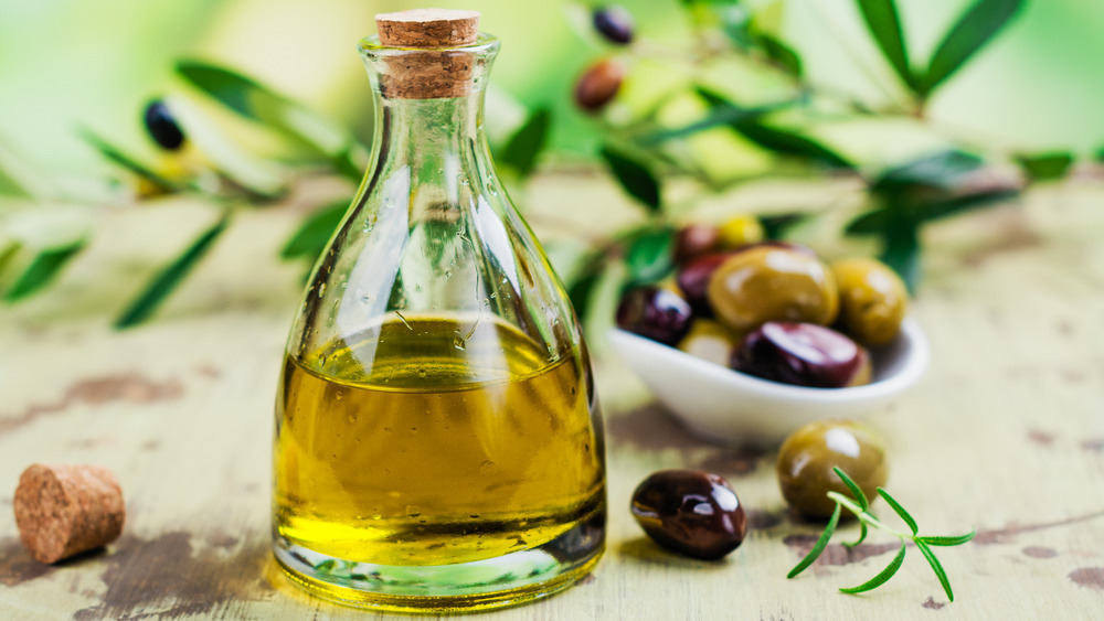 Olive oil with olives and leaves