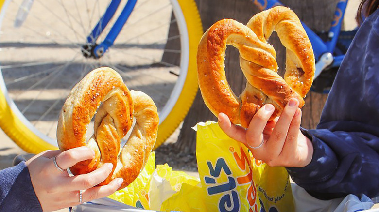 people holding Wetzel's plain pretzels