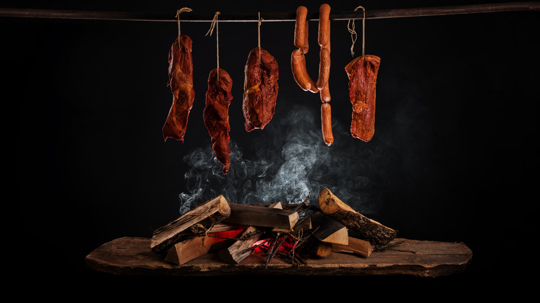 smoked meats smoking in smokehouse