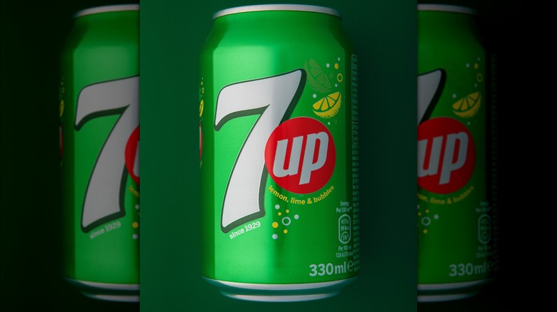 A 7UP can on a green background.