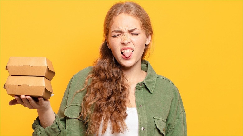 Disgusted woman with fast food