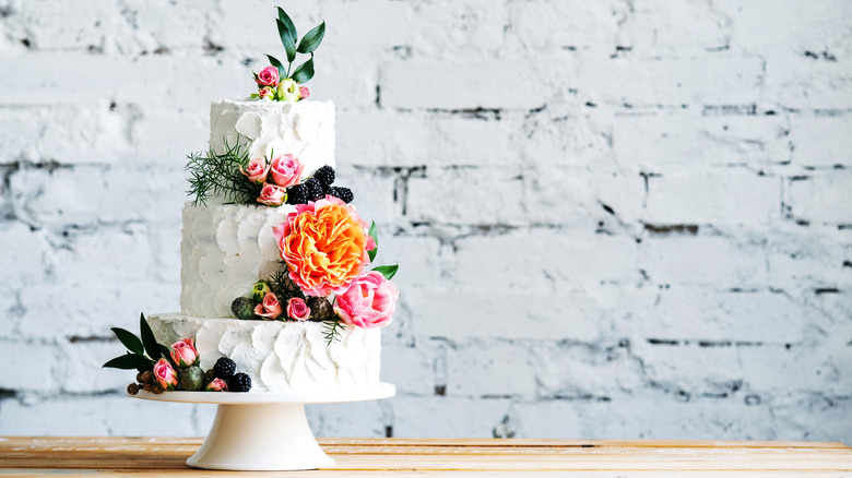 Wedding cake against white brick